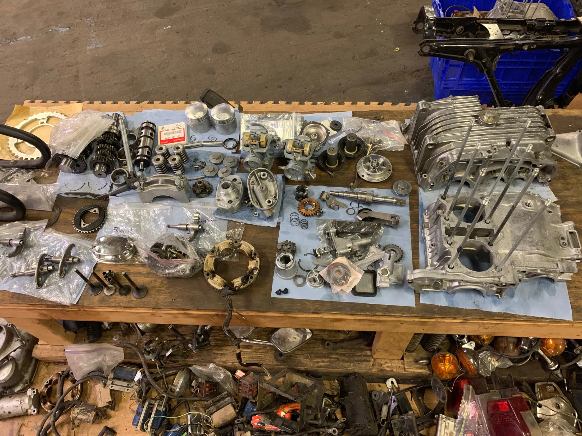 Cleaned engine parts and case halves laid out on a workbench