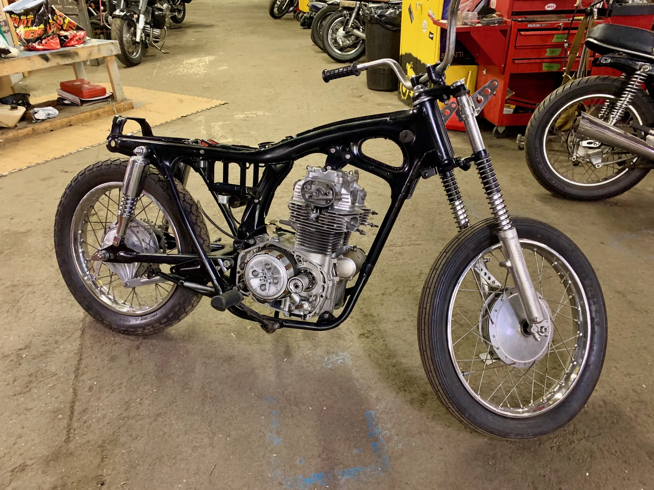 Refinished black frame with the engine and wheels installed