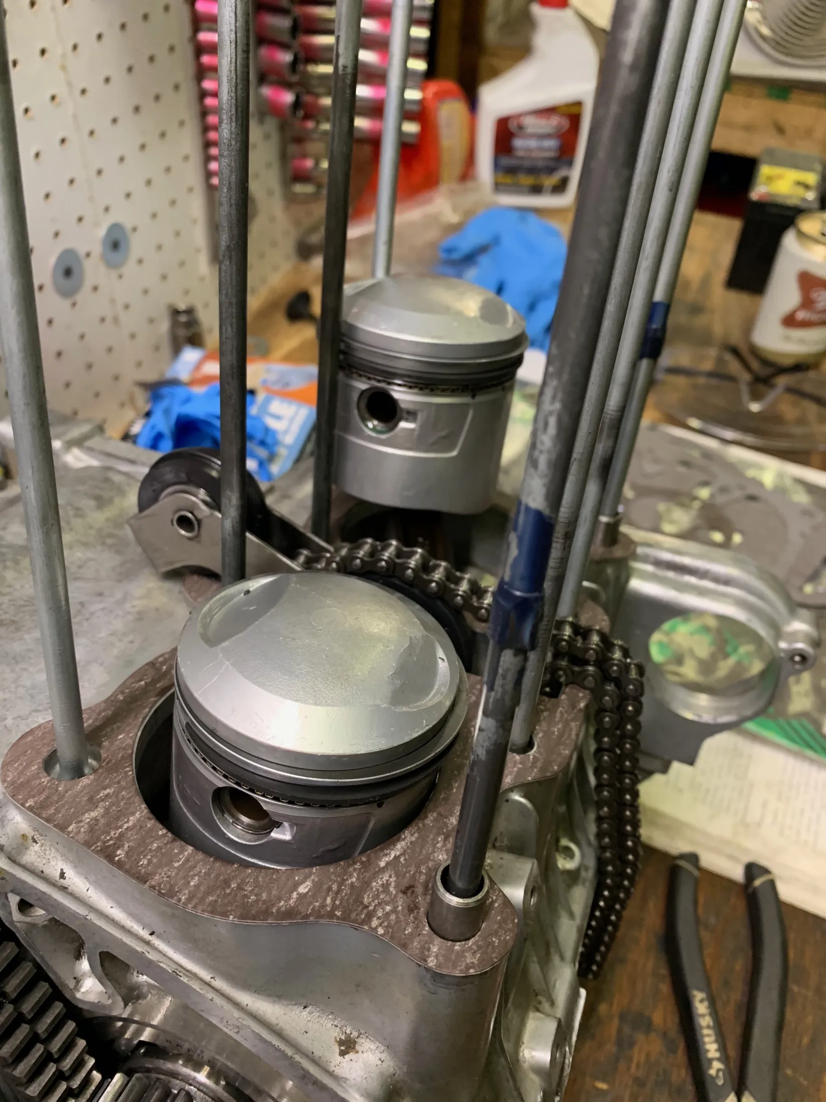 Pistons with new rings fitted to the engine, cam chain alongside